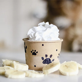 A cup (covered in paw prints) full of delicious cream